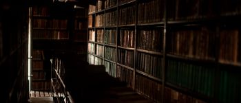 Dark academia libraries are often shrouded in shadow
